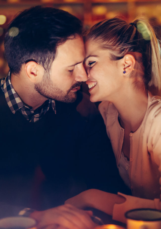Couple leaning in for a kiss