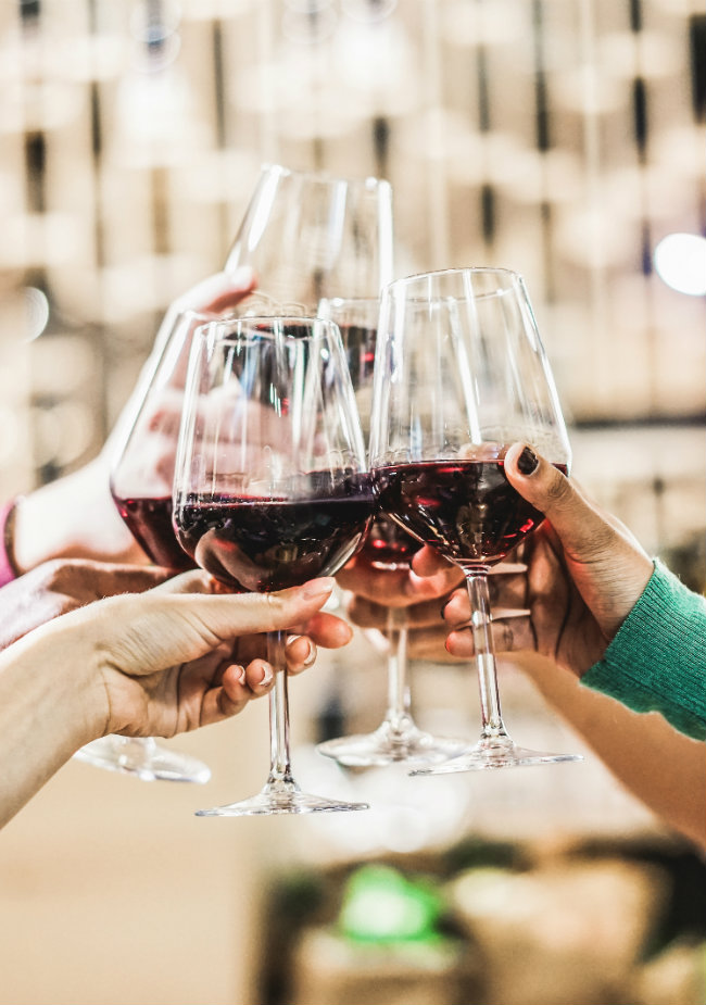 Wine glasses being held up for a toast