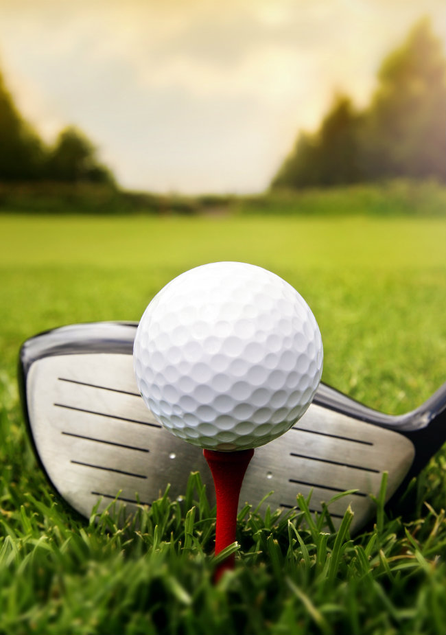 Golf club ready to strike golf ball